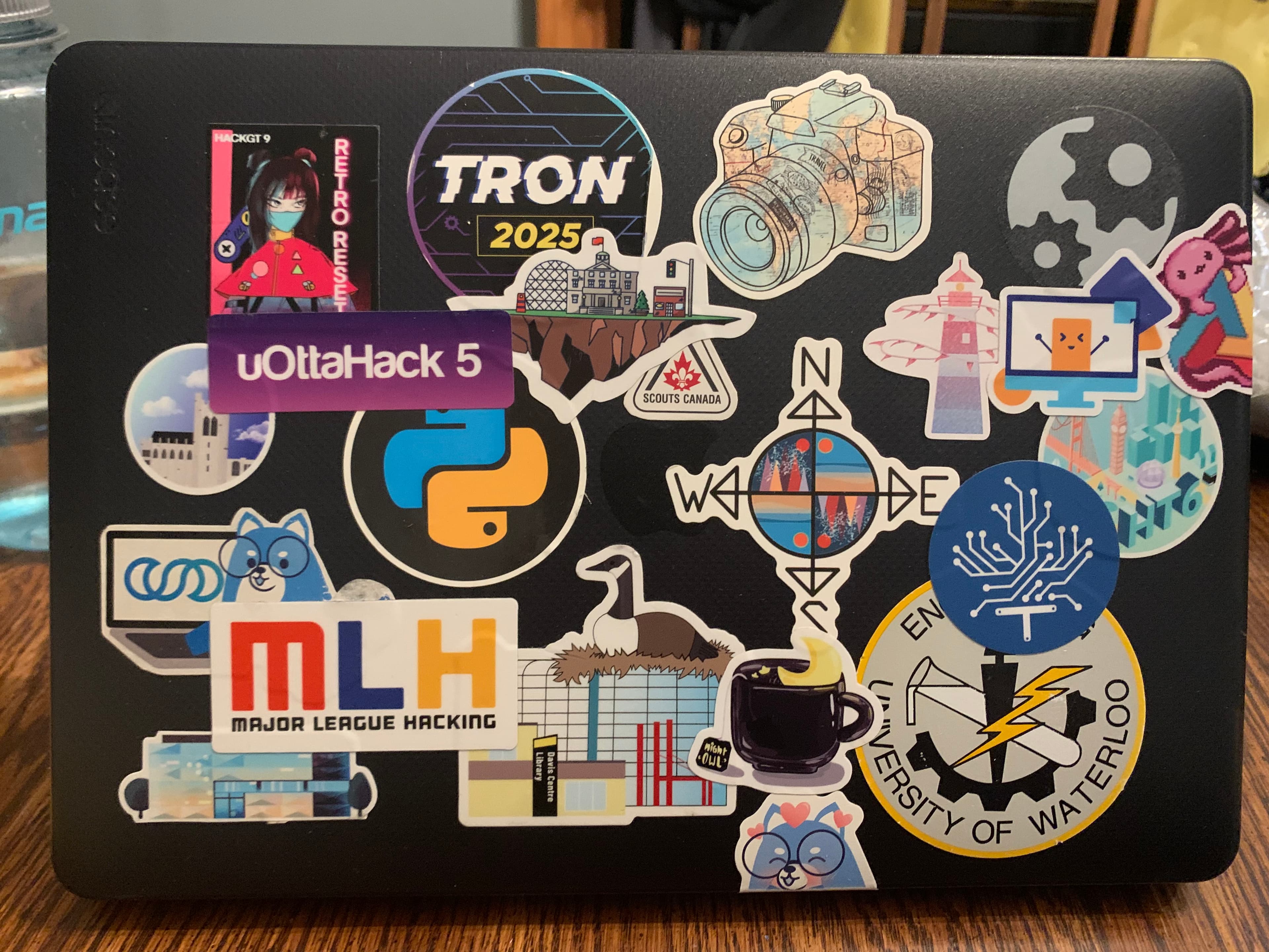 laptop covered with stickers accumulated from hackathons